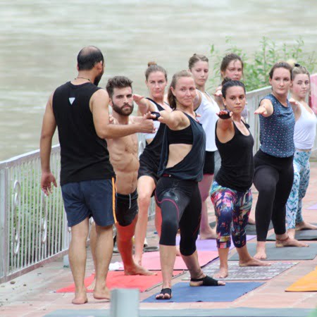 Mantra Yoga Meditation Students Practicing Yoga nearby Ganges